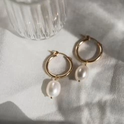 Kana Earrings 16 Kana Earrings -Gldn Shop KanaBoldPearlHoops 7 0d19bf9f 74a7 4300 8c7f f399c5dd86ef